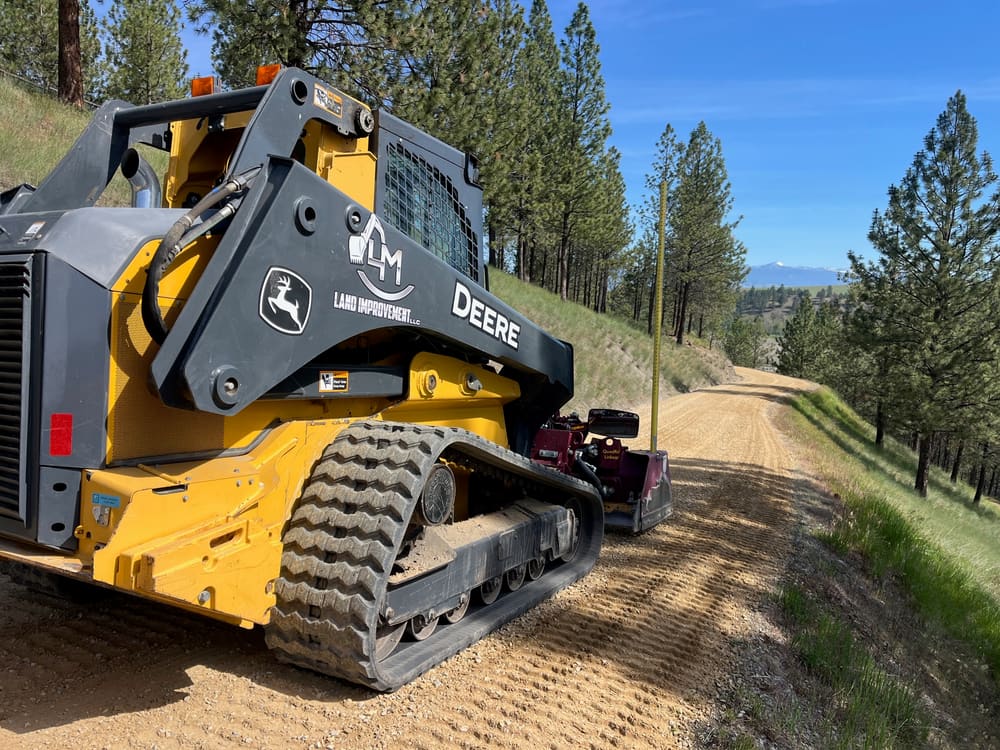 Finishing a gravel road with the track loader